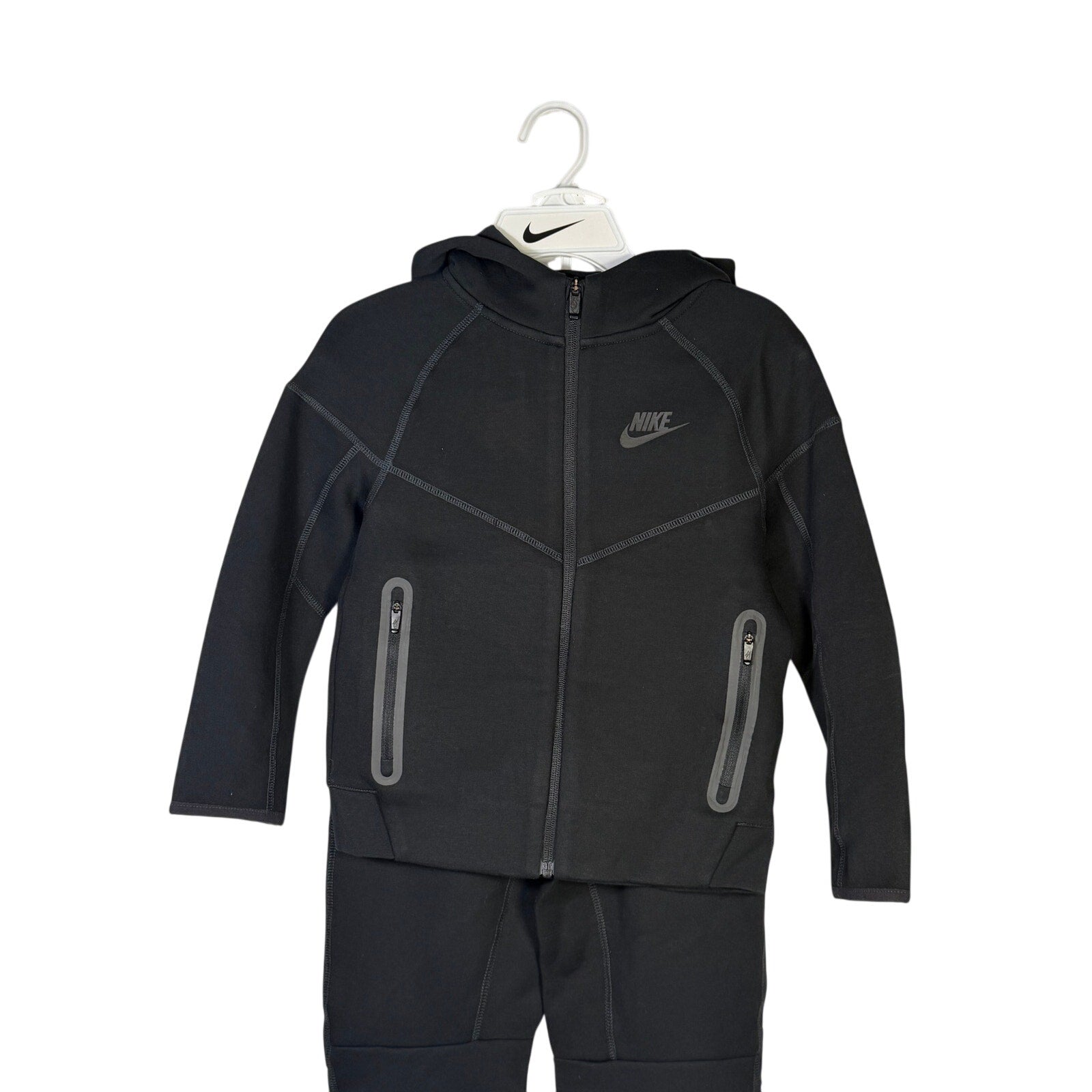 Nike Kids Tech Fleece full-zip hoodie and jogger set in black, size 7, featuring a cozy fleece material and sporty style.