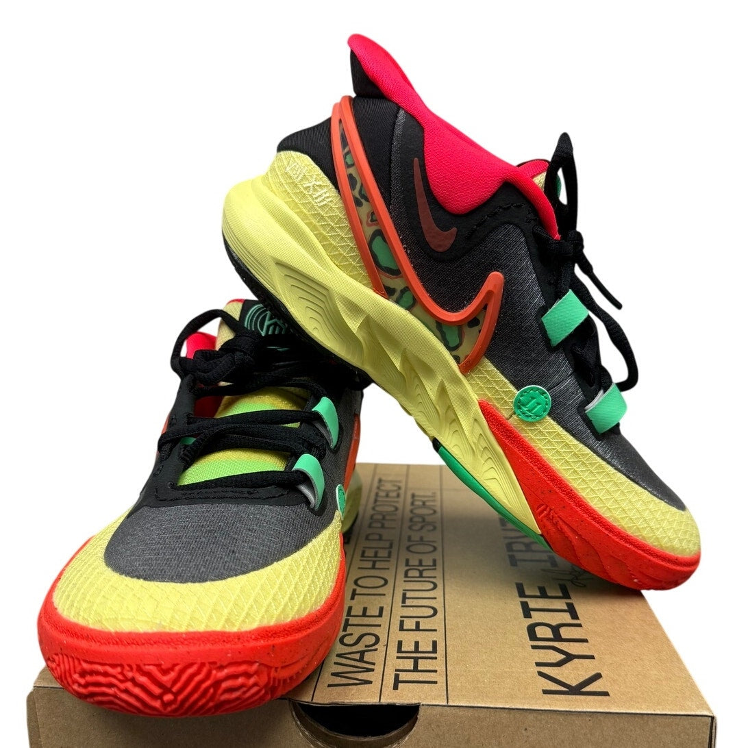 Nike Kyrie 8 GO basketball shoes for grade school in black and lemon chiffon, featuring sleek design and Nike branding.