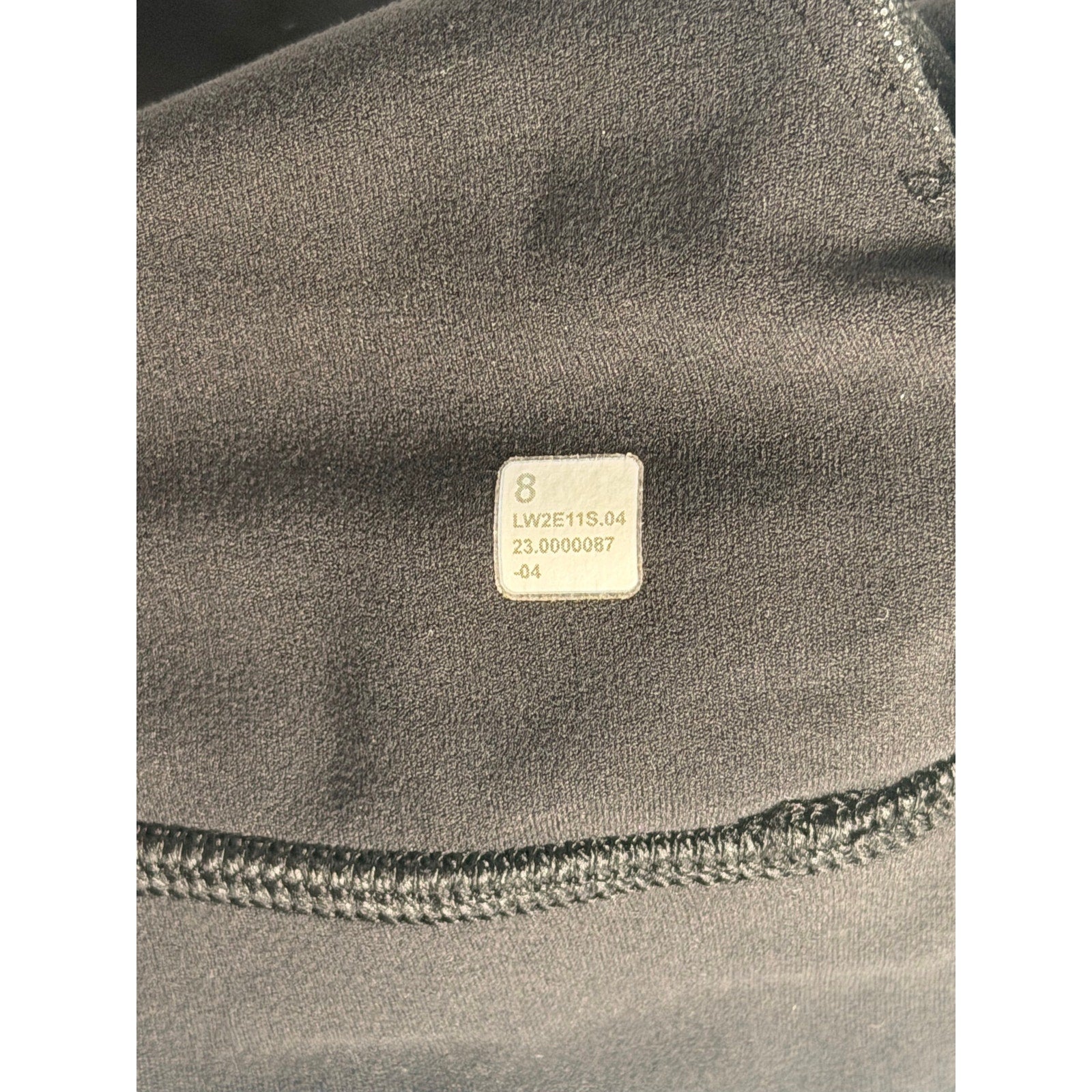 Lululemon women's black one-shoulder foil sports bra, size 8, with sleek design and supportive fit.