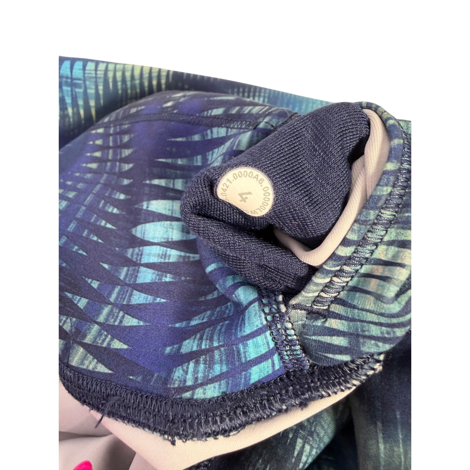 Lululemon women's high-rise full-length leggings in size 4 with blue abstract print, shown laid flat highlighting the design.