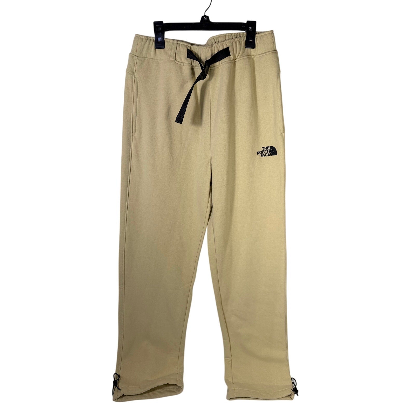 The North Face men's AXYS sweatpants in gravel beige, size small, with drawstring waist and logo detailing, laid flat.