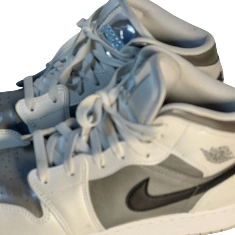 Air Jordan 1 Mid GS sneakers in white, gray, and black for youth size 7Y, featuring classic design and high-top style.