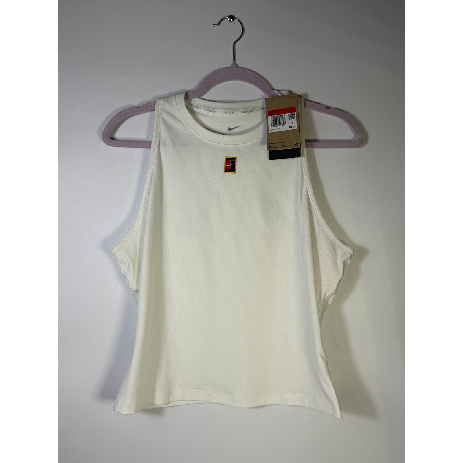 NikeCourt Women's Dri-FIT tennis tank top in white, size large, showing lightweight fabric and athletic fit for active play.