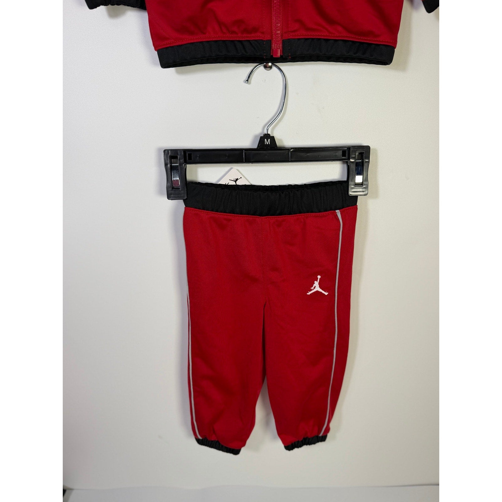 Jordan baby boys 2-piece tracksuit jacket and pants set in red and black, size 12 months, new with tags.