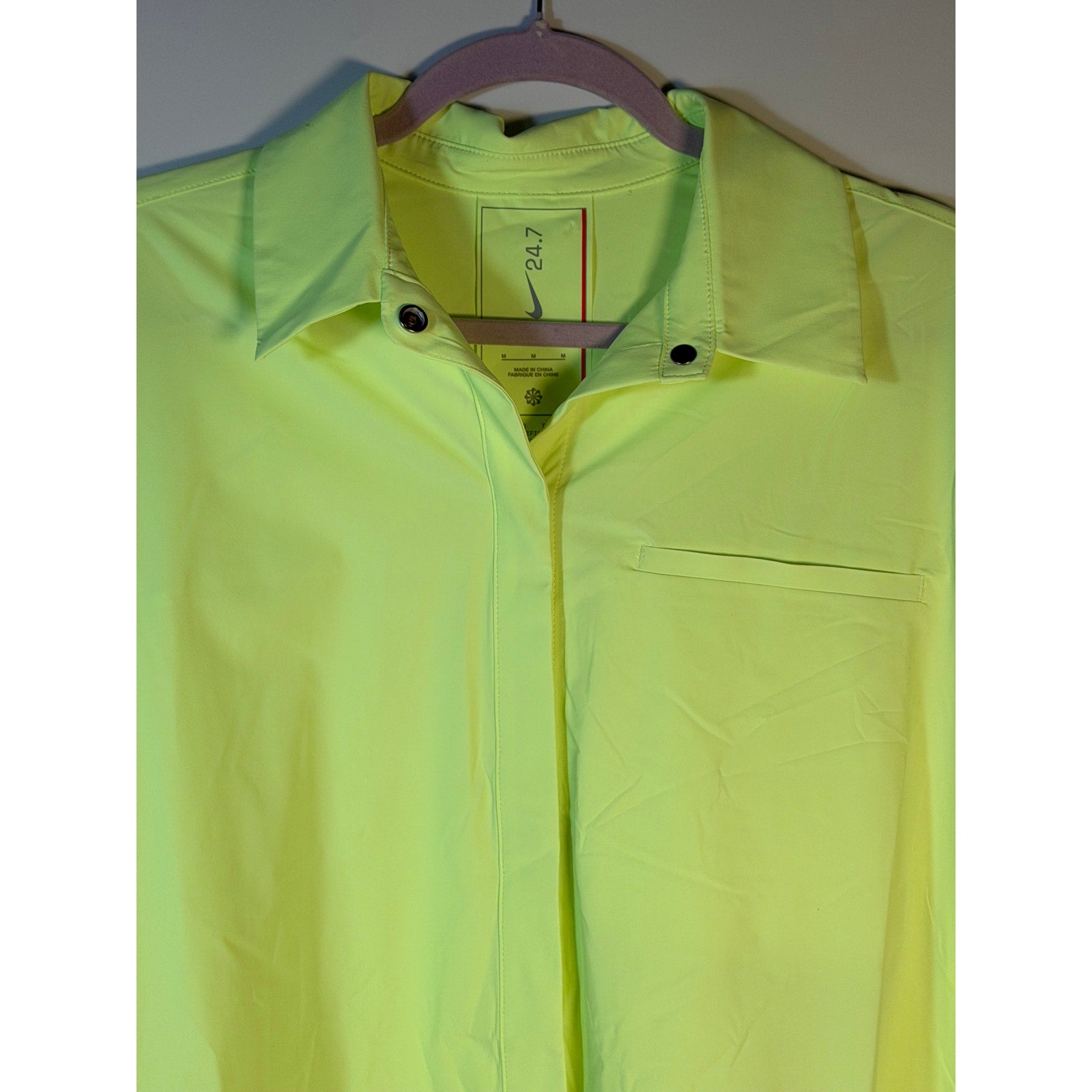 Nike 24.7 Dri-FIT women's long sleeve training shirt in neon yellow, made of moisture-wicking fabric, size medium.