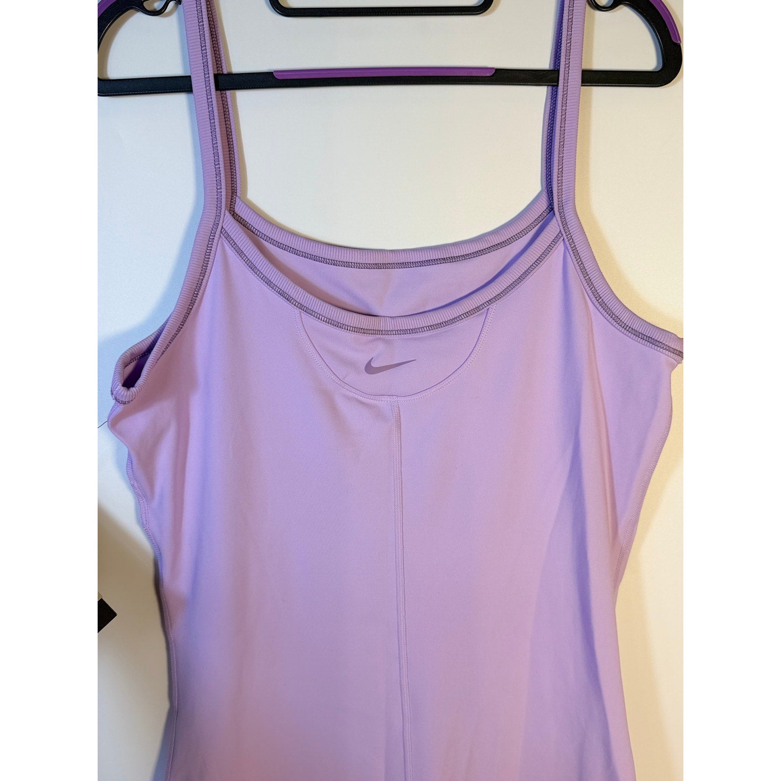 Lavender Nike women's One Dri-FIT training romper bodysuit, large size, front view showing athletic fit and sleeveless design.