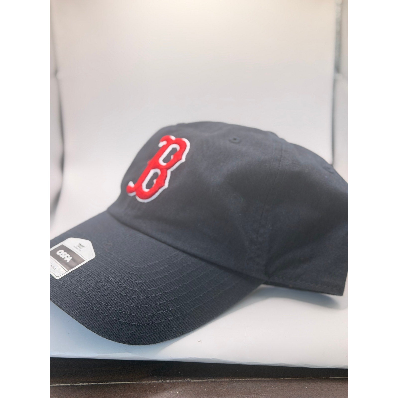 Black New Era Boston Red Sox MLB Clean Up adjustable dad hat with red logo and curved brim, front view.