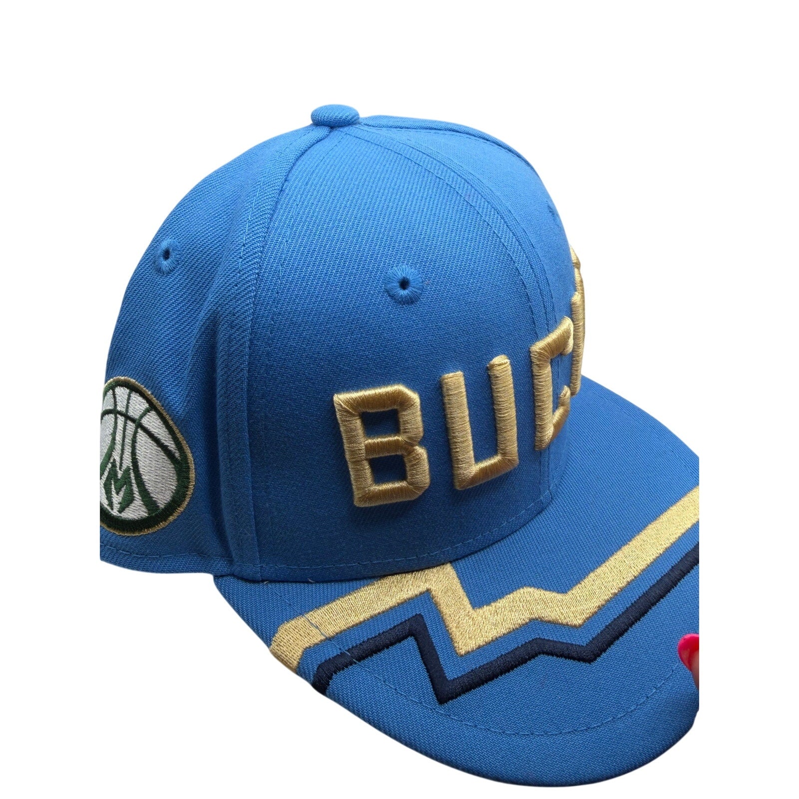 Milwaukee Bucks NBA New Era 9FIFTY snapback hat in blue and gold, featuring team logo, adjustable one size fits all.