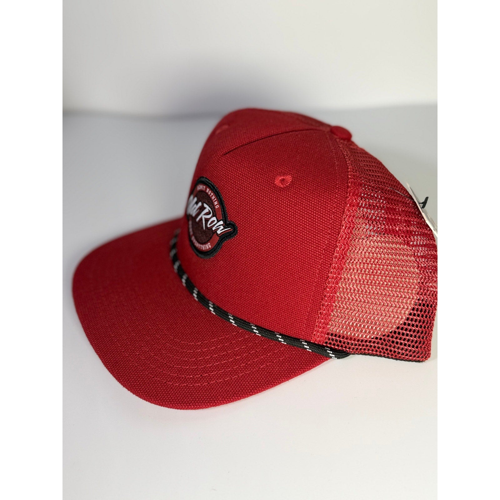 Old Row logo rope trucker hat in red with snapback closure, adult size, stylish baseball cap featuring branding and adjustable fit.