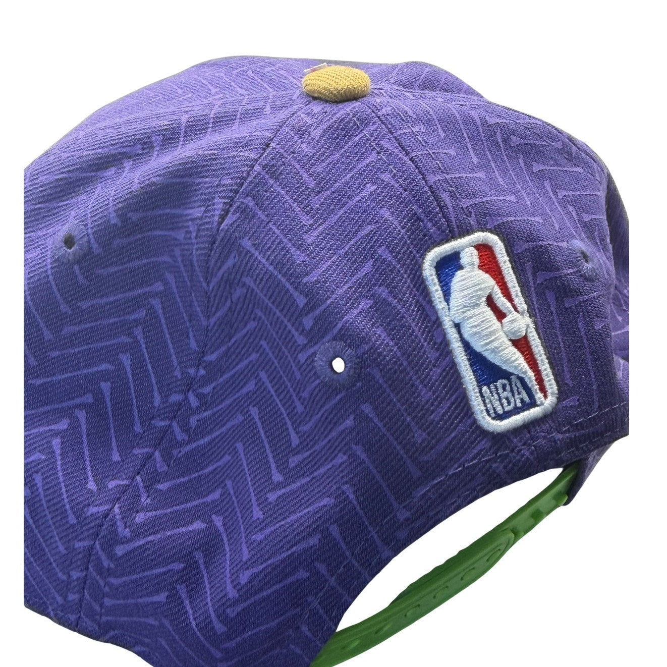 New Era NOLA Pelicans 9FIFTY youth snapback hat in purple and gold, featuring NBA team logo and structured design.