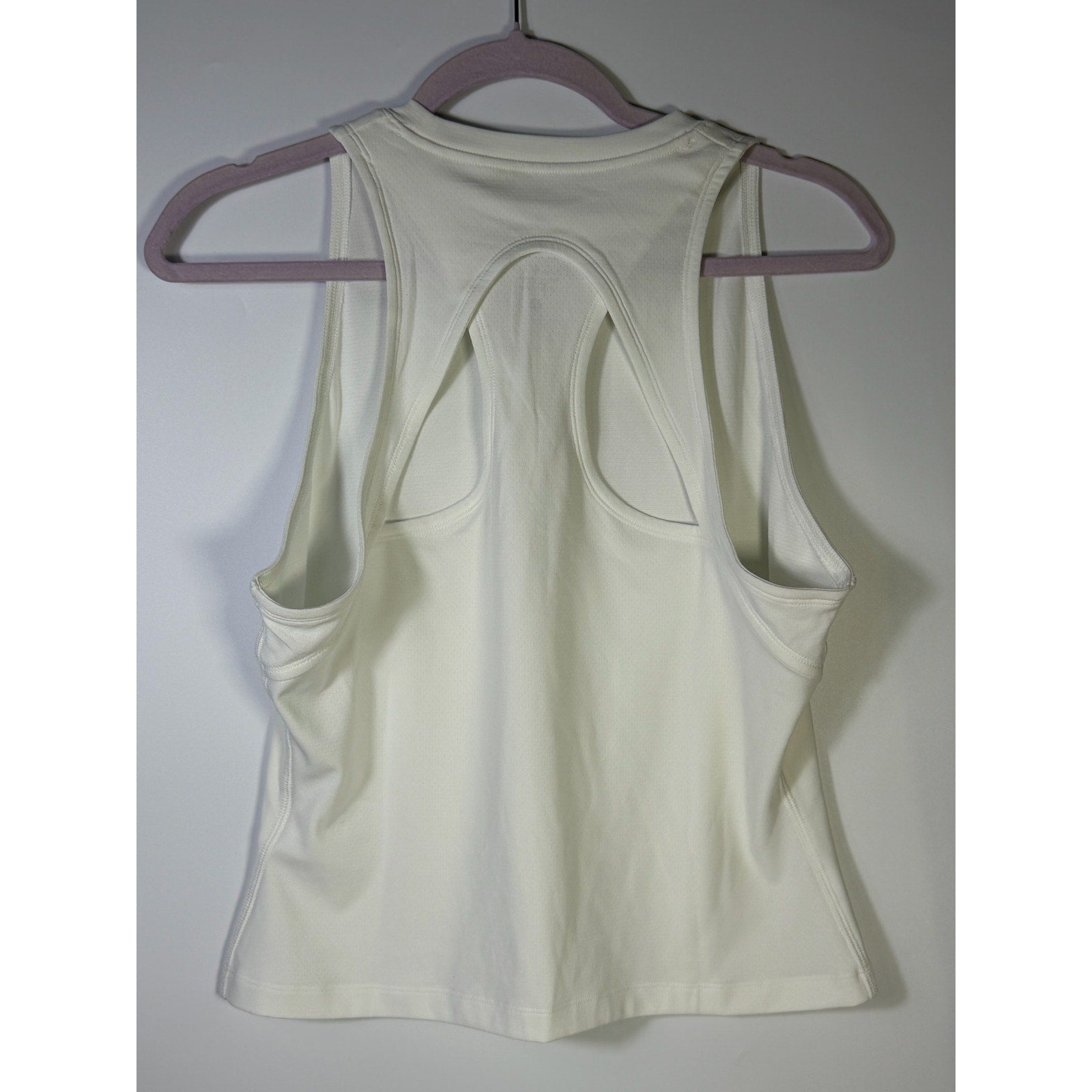 NikeCourt women's white Dri-FIT tennis tank top, size large, with sleeveless design and lightweight fabric, ideal for active sportswear.