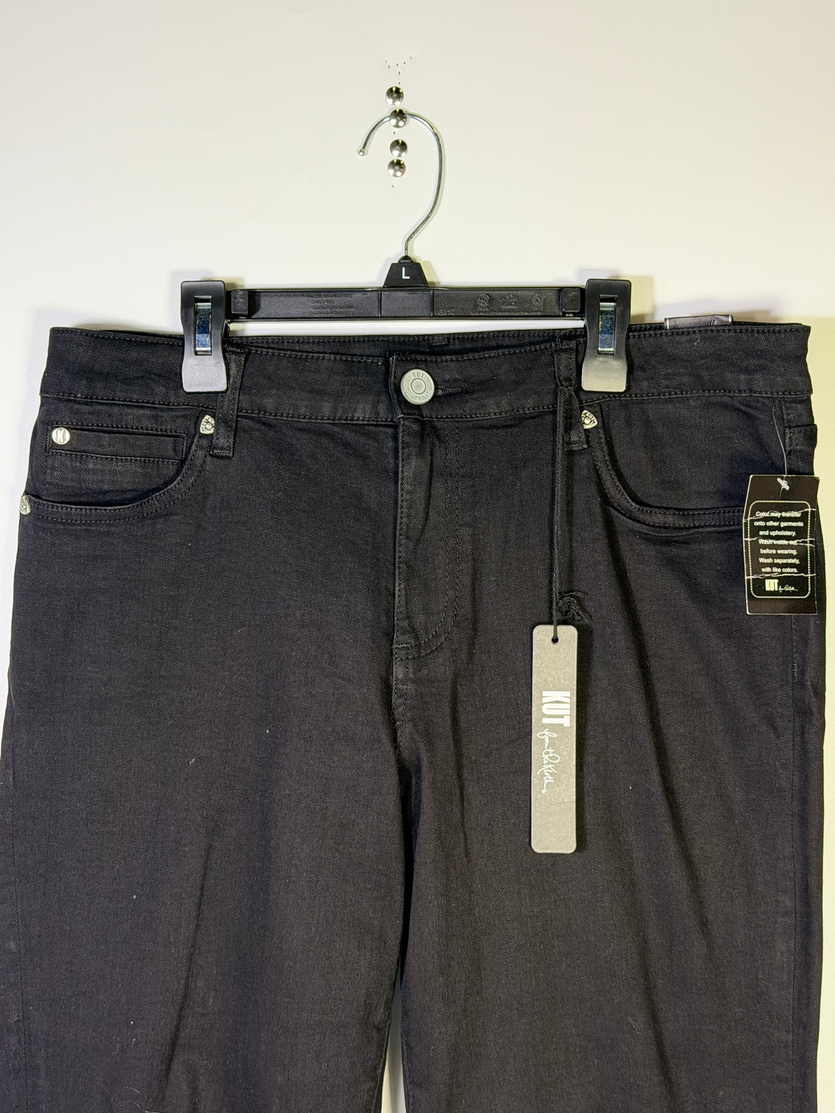 KUT from the Kloth black straight leg jeans in size 12, displayed on a hanger with a focus on fit and fabric texture.