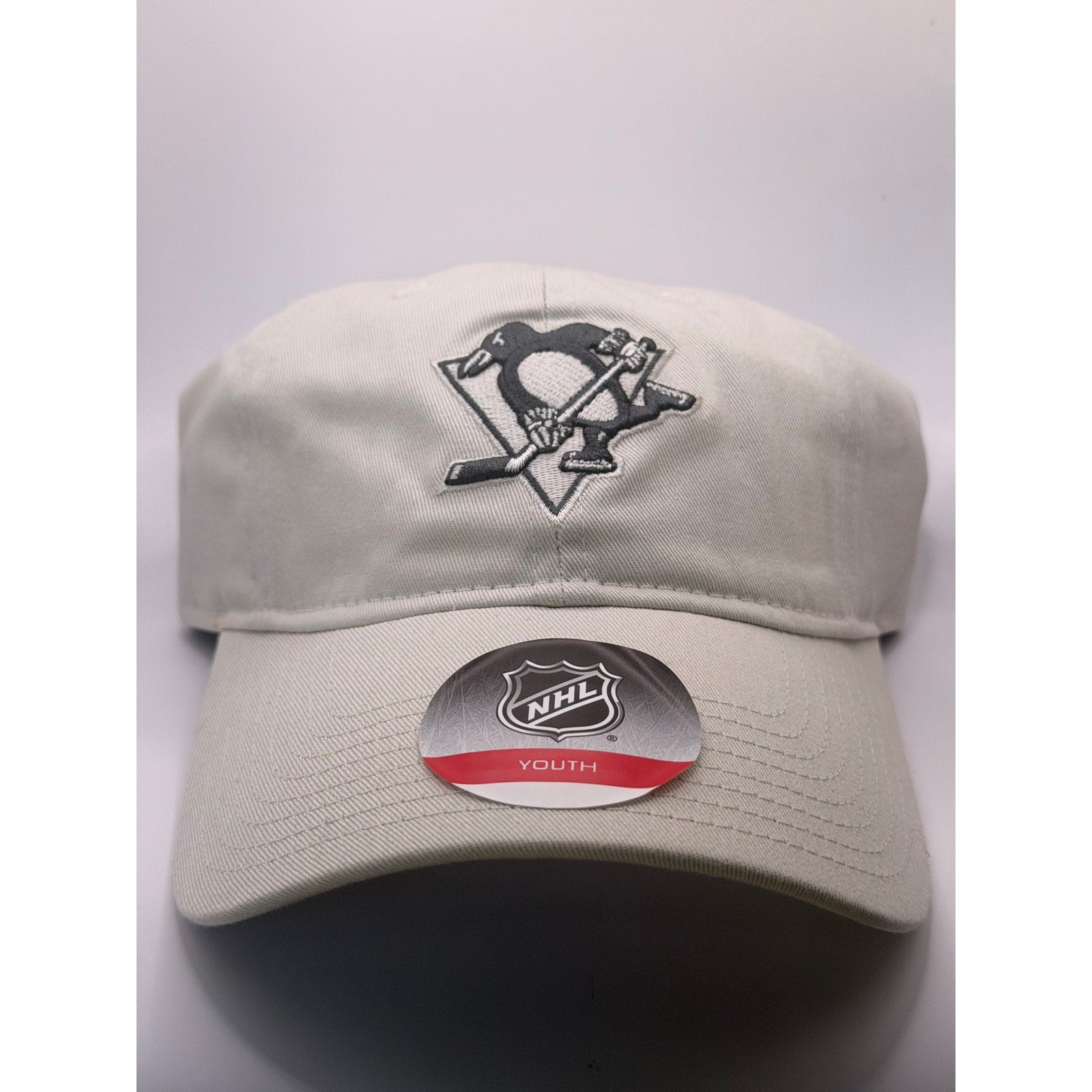 Beige Pittsburgh Penguins NHL youth adjustable strapback hat with embroidered logo and curved brim.
