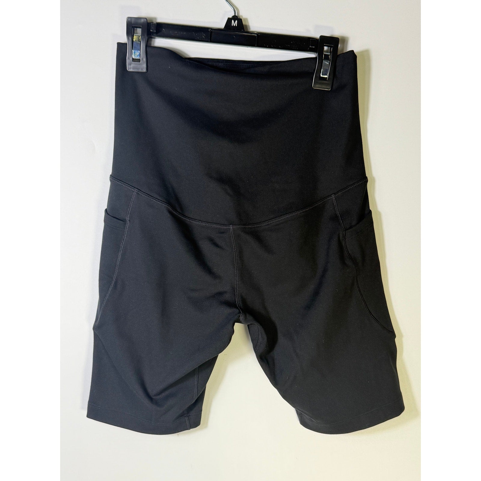 Nike women's black high-waisted training bike shorts, small size, shown on a model with a sleek, athletic fit.