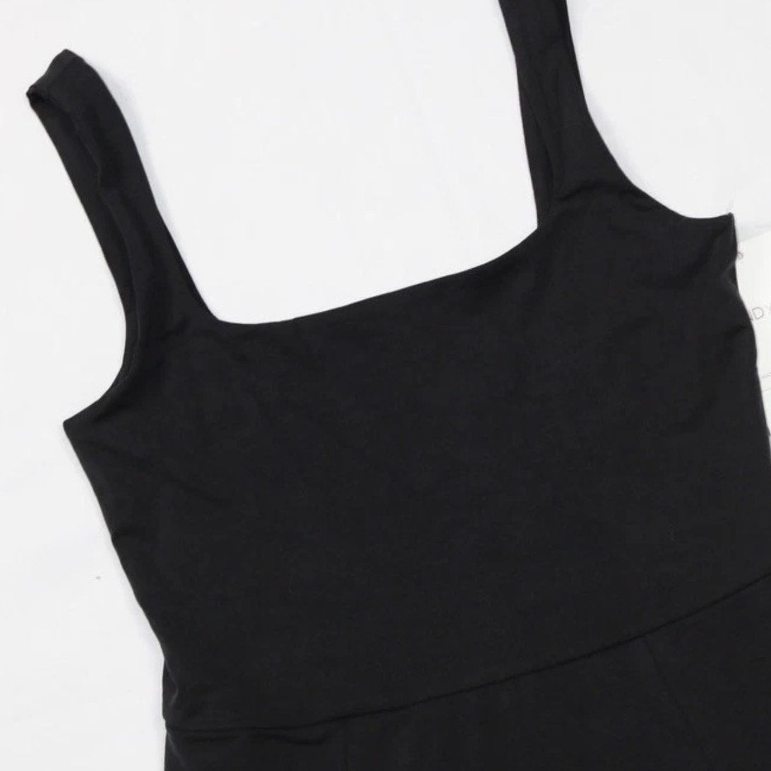 Black Beyond Yoga Charmed Fit & Flare Mini Dress for women, size medium, shown on a hanger with a fitted bodice and flared skirt.