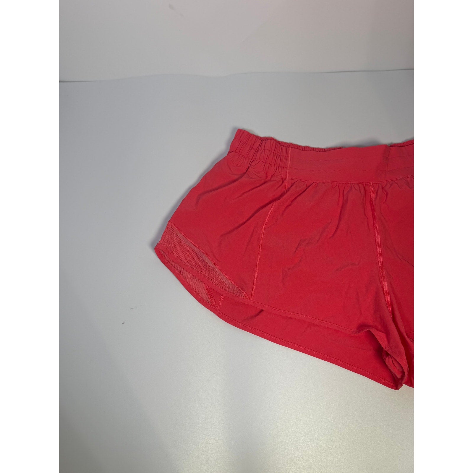 Lululemon Hotty Hot Low Rise Lined Shorts in Glaze Pink, women's size 14, with 2.5-inch inseam, shown on a model.