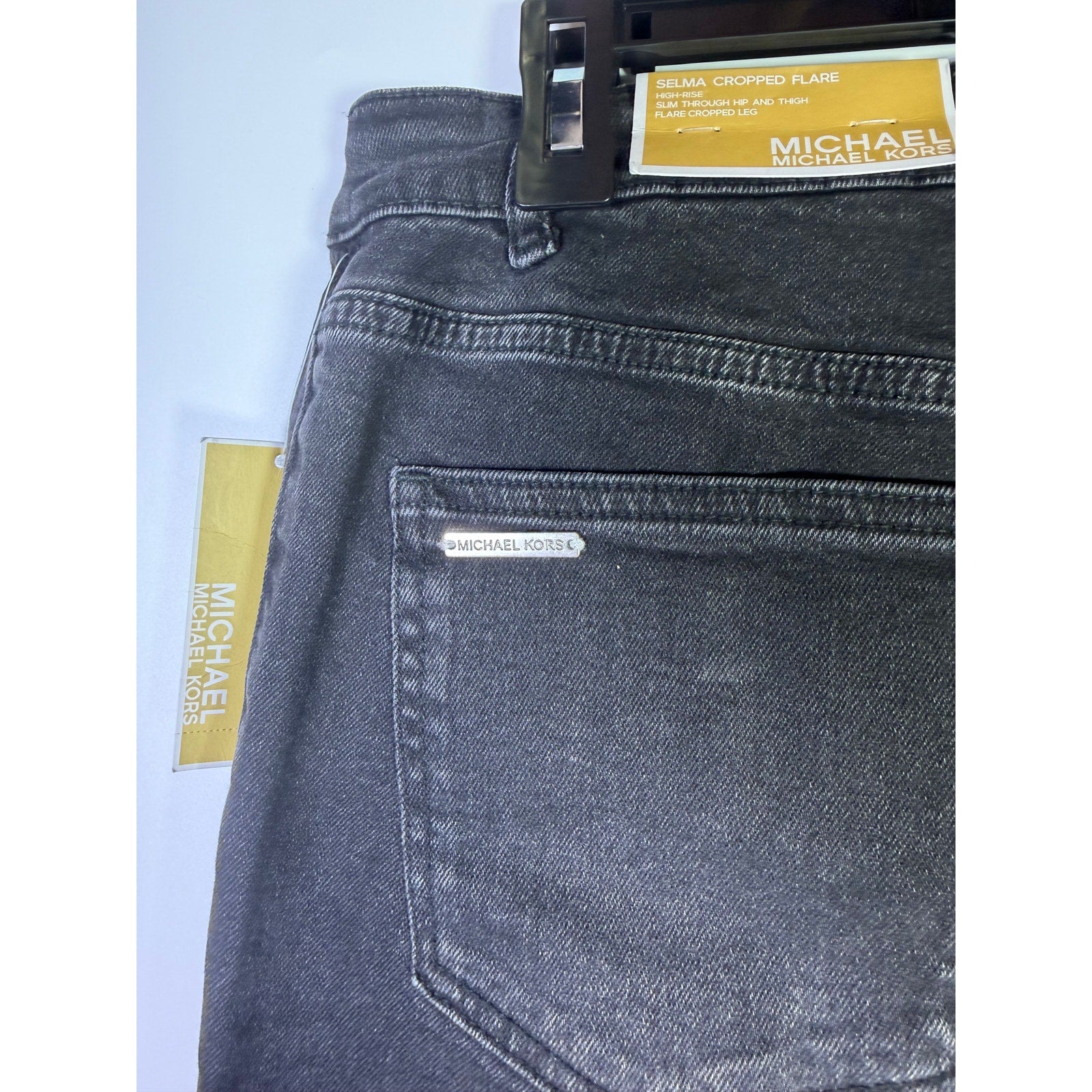 MICHAEL Michael Kors women's black cropped flare jeans with washed finish, size 4, showing the fit and style details.