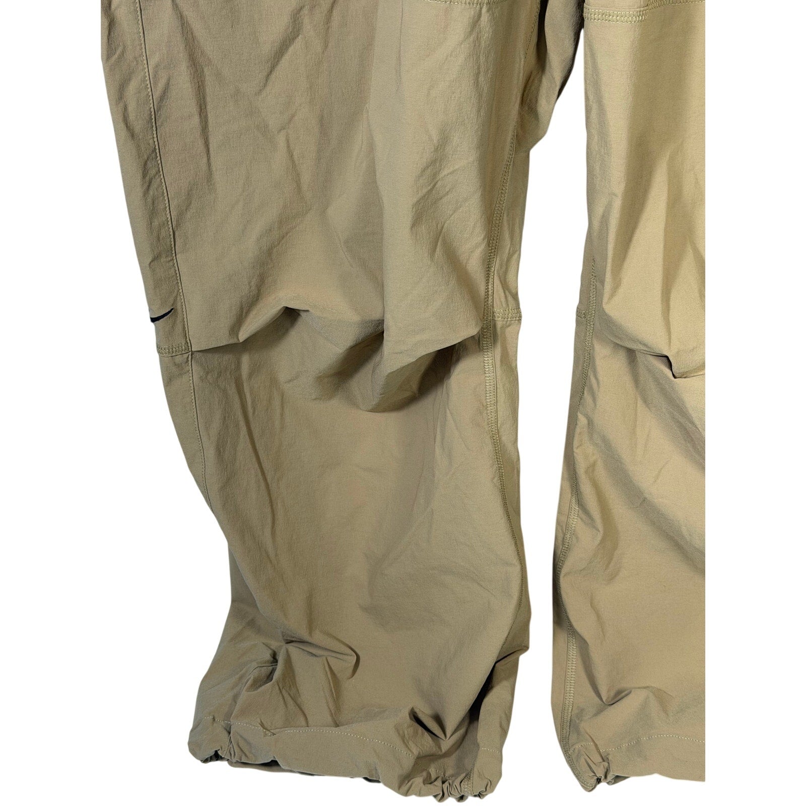 Nike Tech men's oversized woven parachute beige pants, size L, featuring a relaxed fit and lightweight fabric.