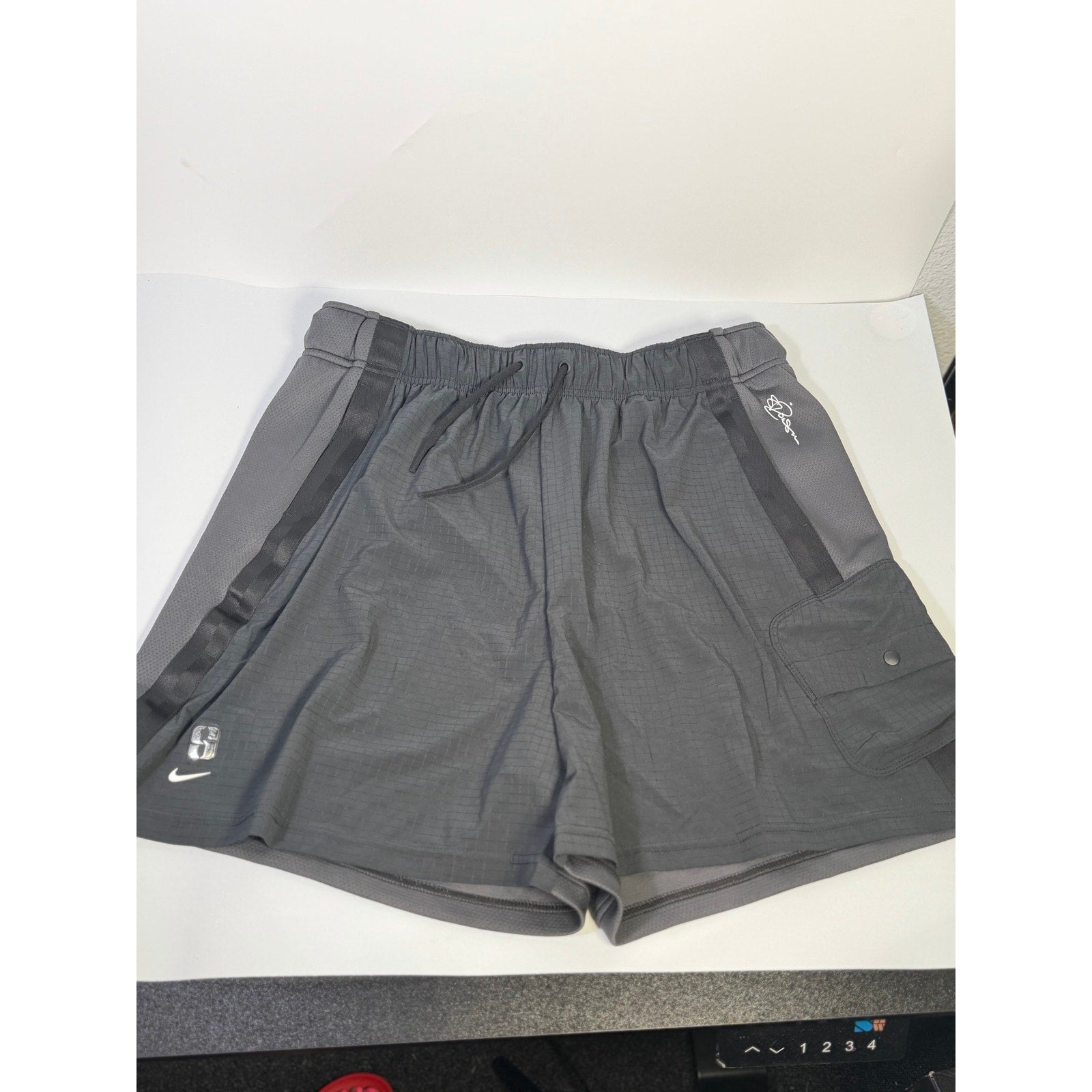 Nike ACG Death Bloom women's cargo shorts in black, size M, featuring a relaxed fit and cargo pockets.