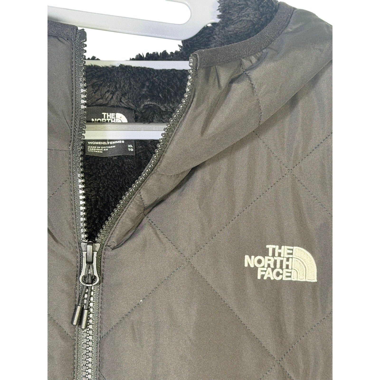 The North Face Women’s Shady Glade insulated parka in black, size XL, showing the jacket's front view with hood and quilted design.