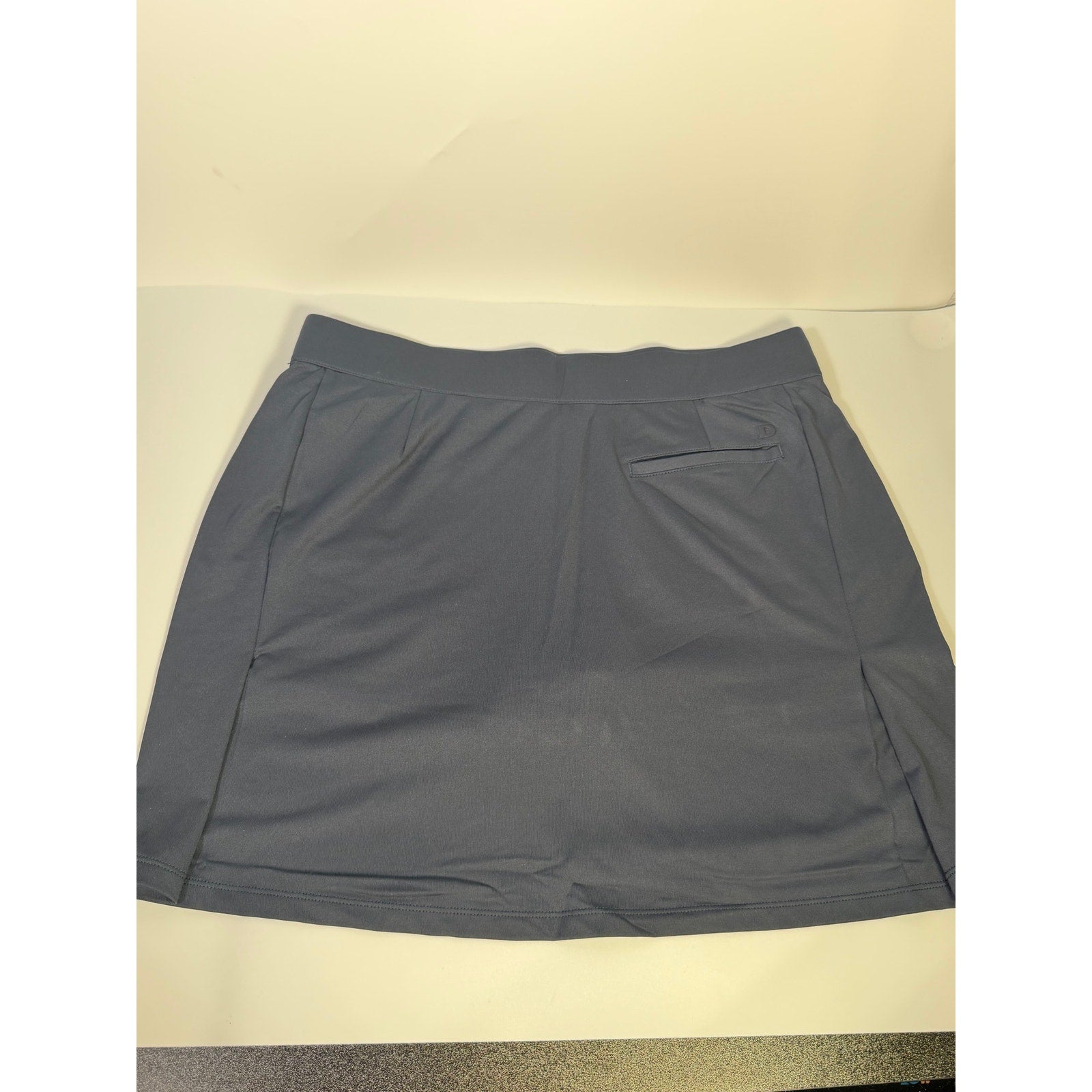 Dunning women's navy golf skort with built-in shorts, athletic style, size large, showing front view and skirt details.
