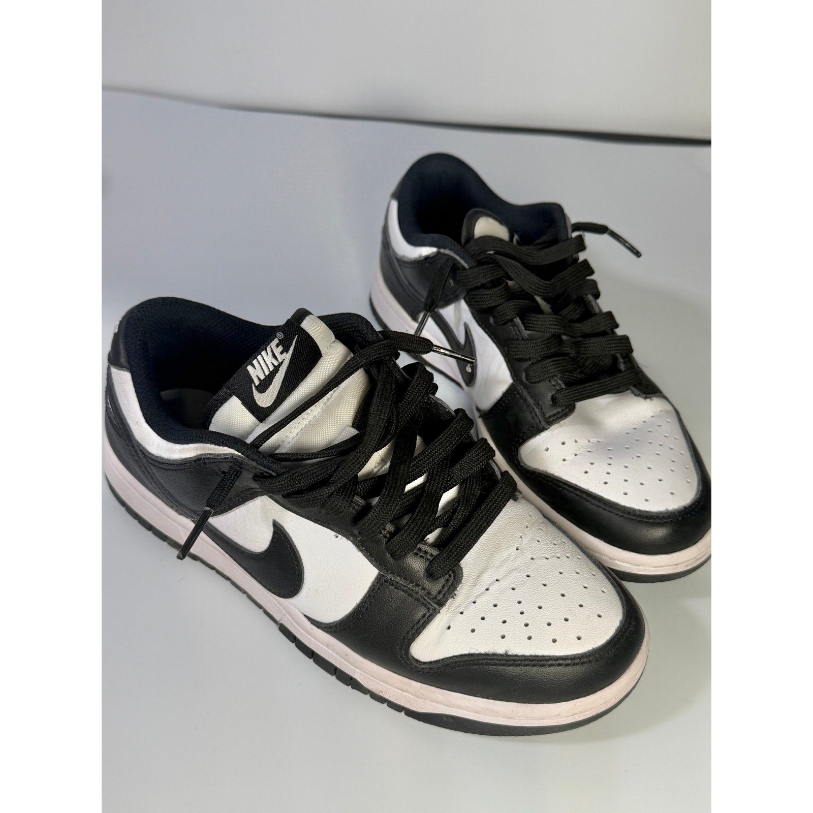 Nike Dunk Low Panda sneakers for youth in size 5Y, black and white colorway, with classic low-top design and Nike branding.