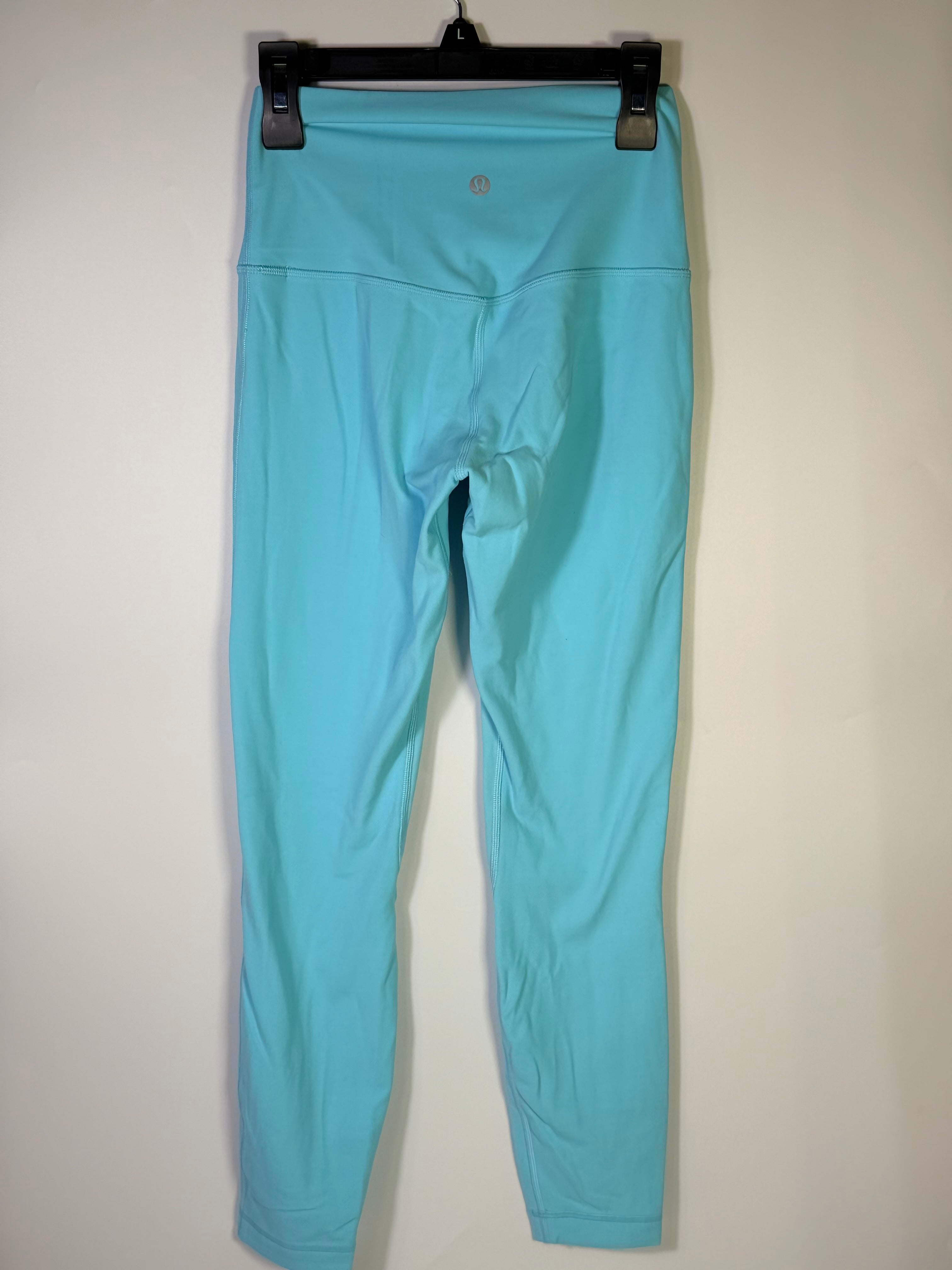 Lululemon women's size 4 aqua blue high-rise full-length leggings laid flat, showcasing the stretchy, smooth fabric and high waistband.