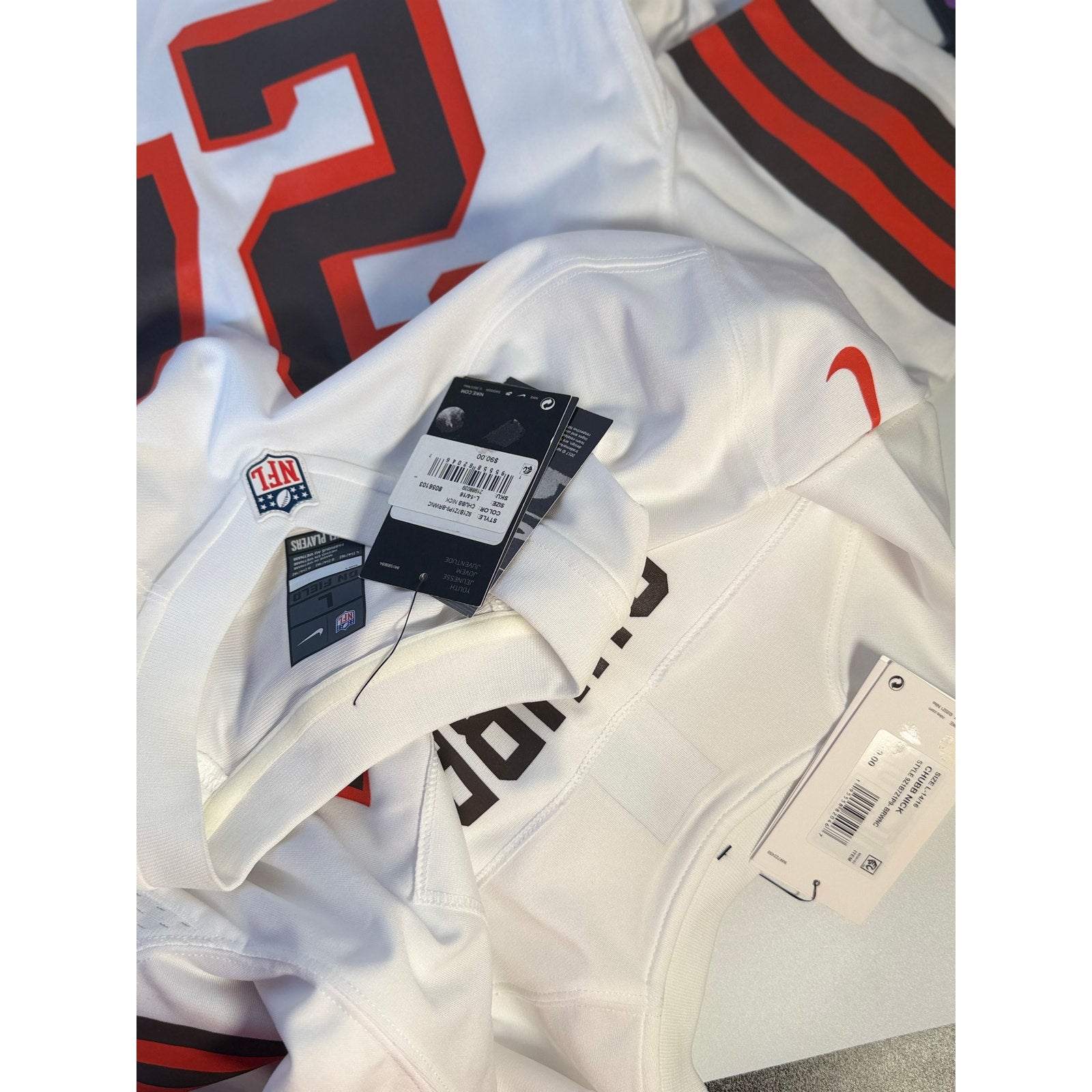 Nike Cleveland Browns #24 NFL youth white game jersey, size large 14-16, with team logo and player number visible.